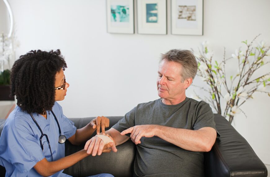 Nurse visiting man with wrist injury